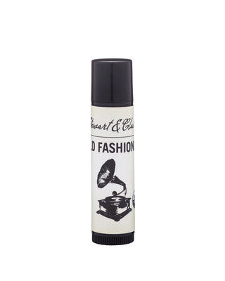 An image of a .15 ounce black plastic tube with an off-white label. The top of the label says Stewart & Claire in black script. Underneath says Old Fashioned. There is a black and white illustration of a gramophone.